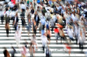 City street aerial photo of people in motion on a crosswalk