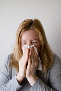 Woman with tissue at nose