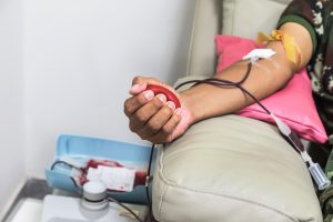 Person's arm with tube for blood donation