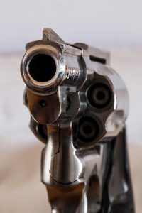 Photo of a handgun, looking down the barrel