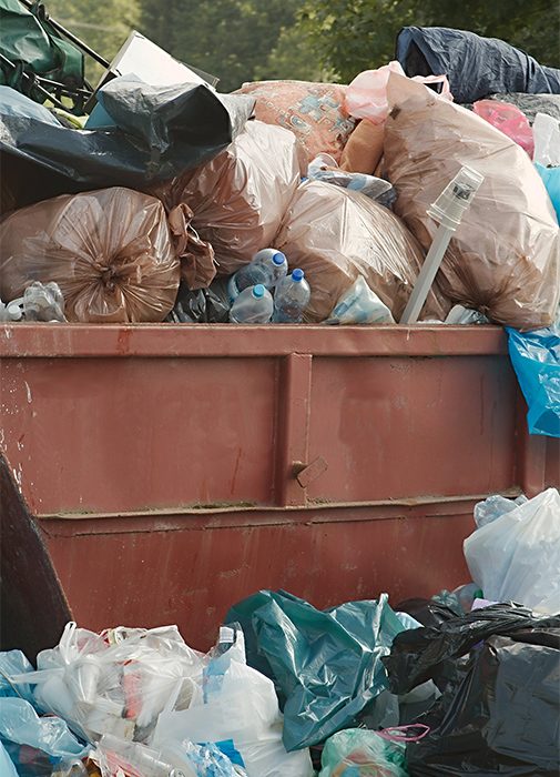 A photo of a dumpster overflowing with trash