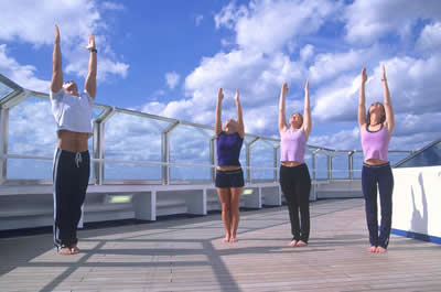 4 people doing yoga on a sunny day