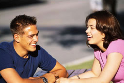 Man and woman talking outside and laughing