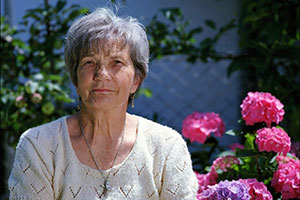 elderly woman sitting in garden