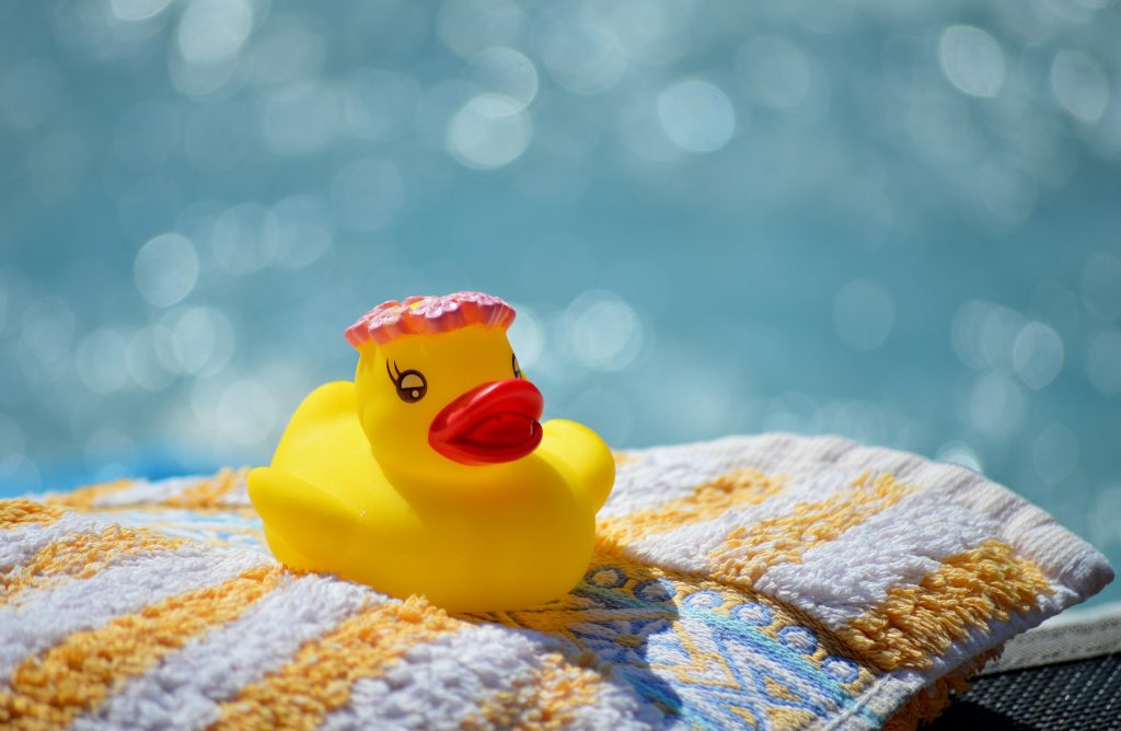 rubber duck on towel by pool