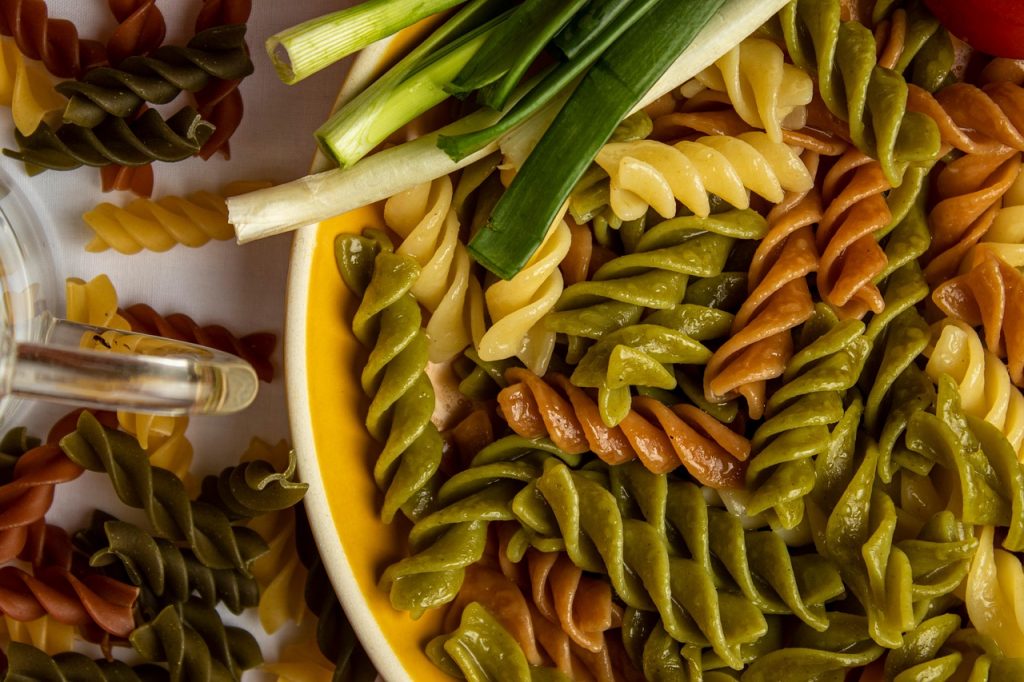Close up of multicolored (green, white, and red) spiral pasta