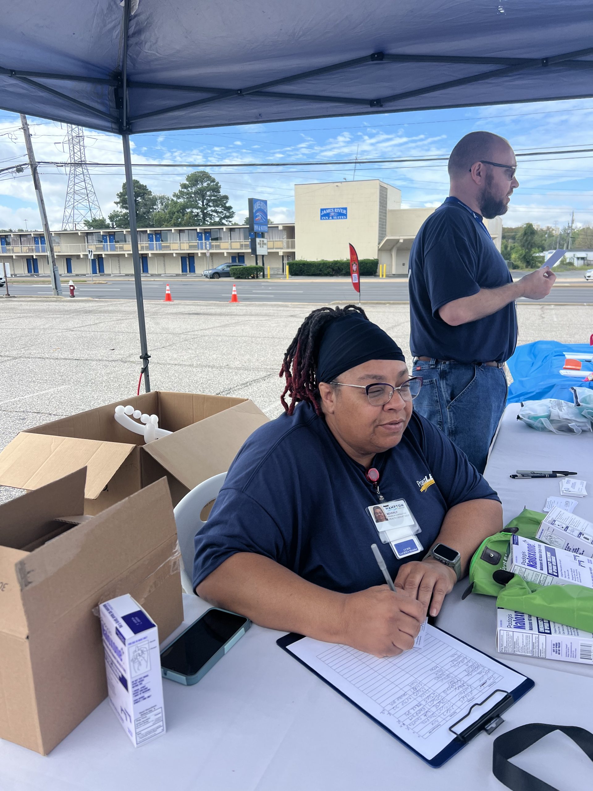 Picture of our Peer Recovery Specialist talking to a community member.