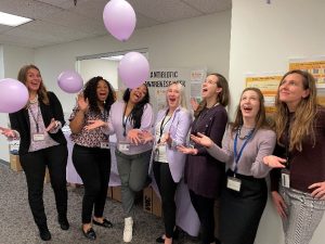 Photo of Fairfax County Health Department staff celebrating Antimicrobial Awareness Week with purple balloons.