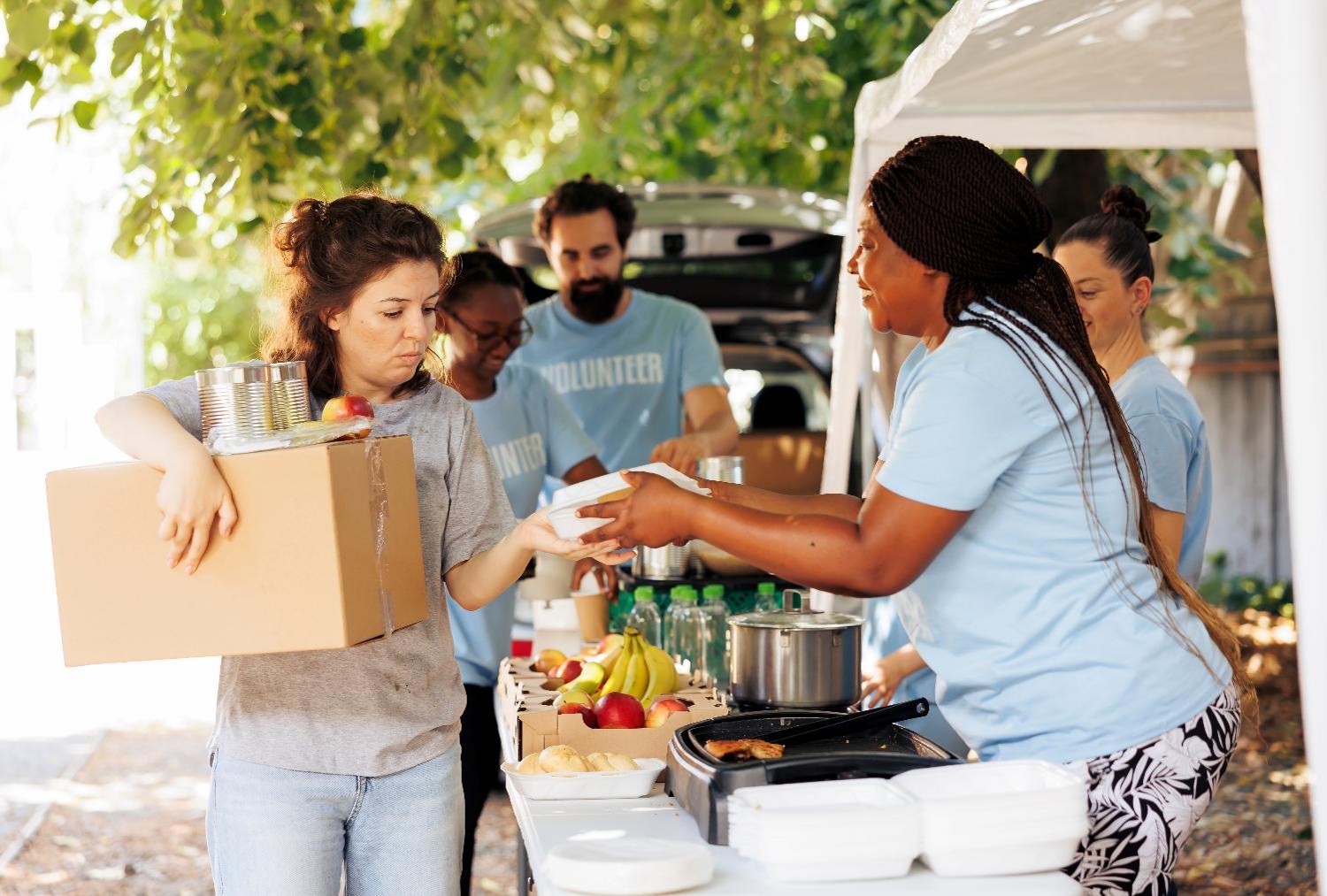 Community members receiving food and support through a local community health outreach event