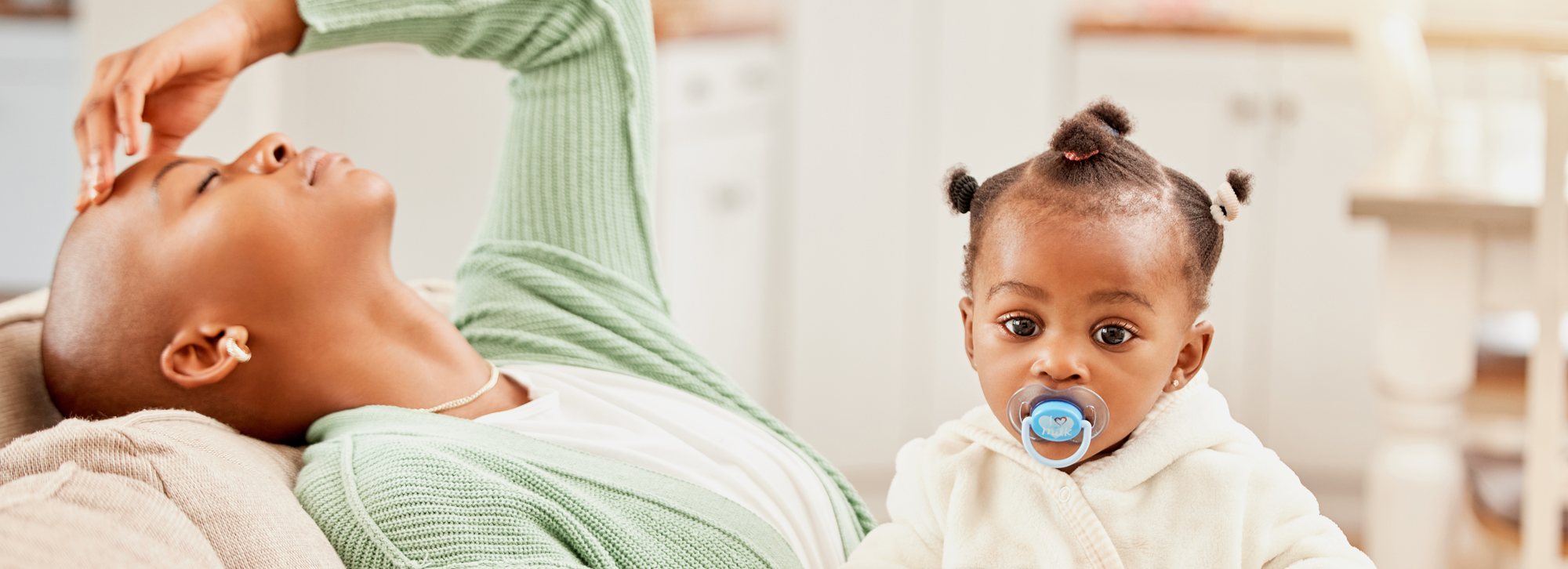 Exhausted young woman with baby