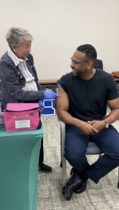 A photo of State Heath Commissioner Dr. Webb getting a flu shot