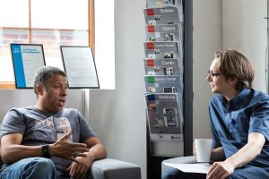 Two people talking at an informal meeting
