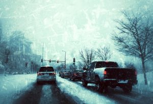 Vehicles at stoplight on a snowy day